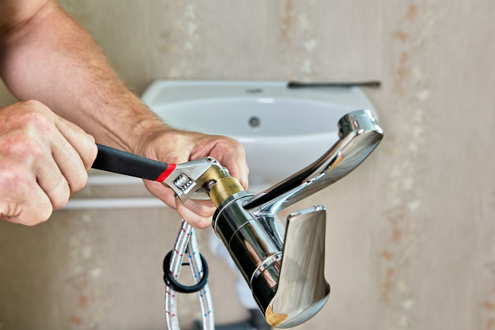 plumber installing a new faucet Richmond, VA