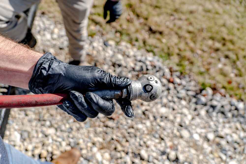 Technician Carrying Hydro Jetting Tools