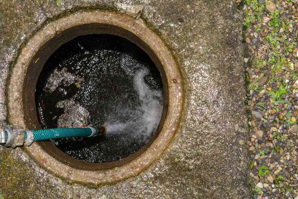 technician hydro jetting a drain